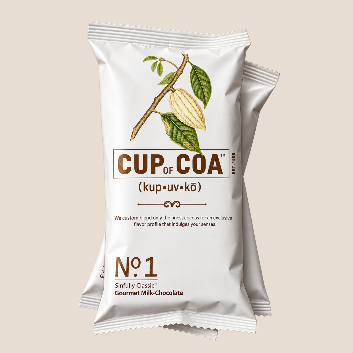 A single white cupcake wrapper for Cup of Coa Gourmet Milk Chocolate No. 1, featuring a brown cocoa pod illustration on a beige background.