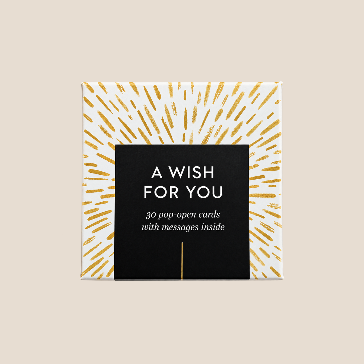 A square gift box or card set cover reading 'A WISH FOR YOU' with '30 pop-open cards with messages inside.' The design has a black central panel and a white background with gold radiating brushstroke lines, shown on a light beige background.