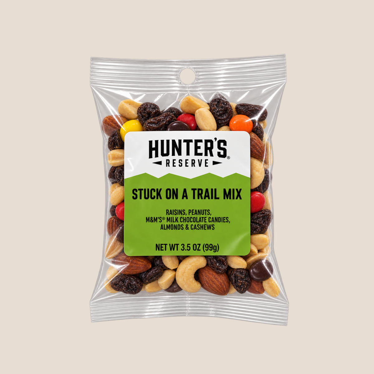 A 3.5 oz bag of Hunter's Reserve Stuck On A Trail Mix, featuring a clear resealable pouch with a white and green label, filled with nuts, raisins, and candy pieces, set against a solid beige background.