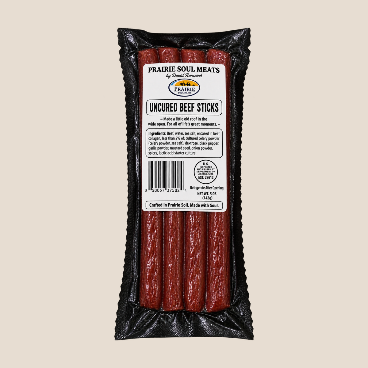 A package of Prairie Soul Meats Uncured Beef Sticks in a black plastic bag with a white product label, shown against a solid beige background.