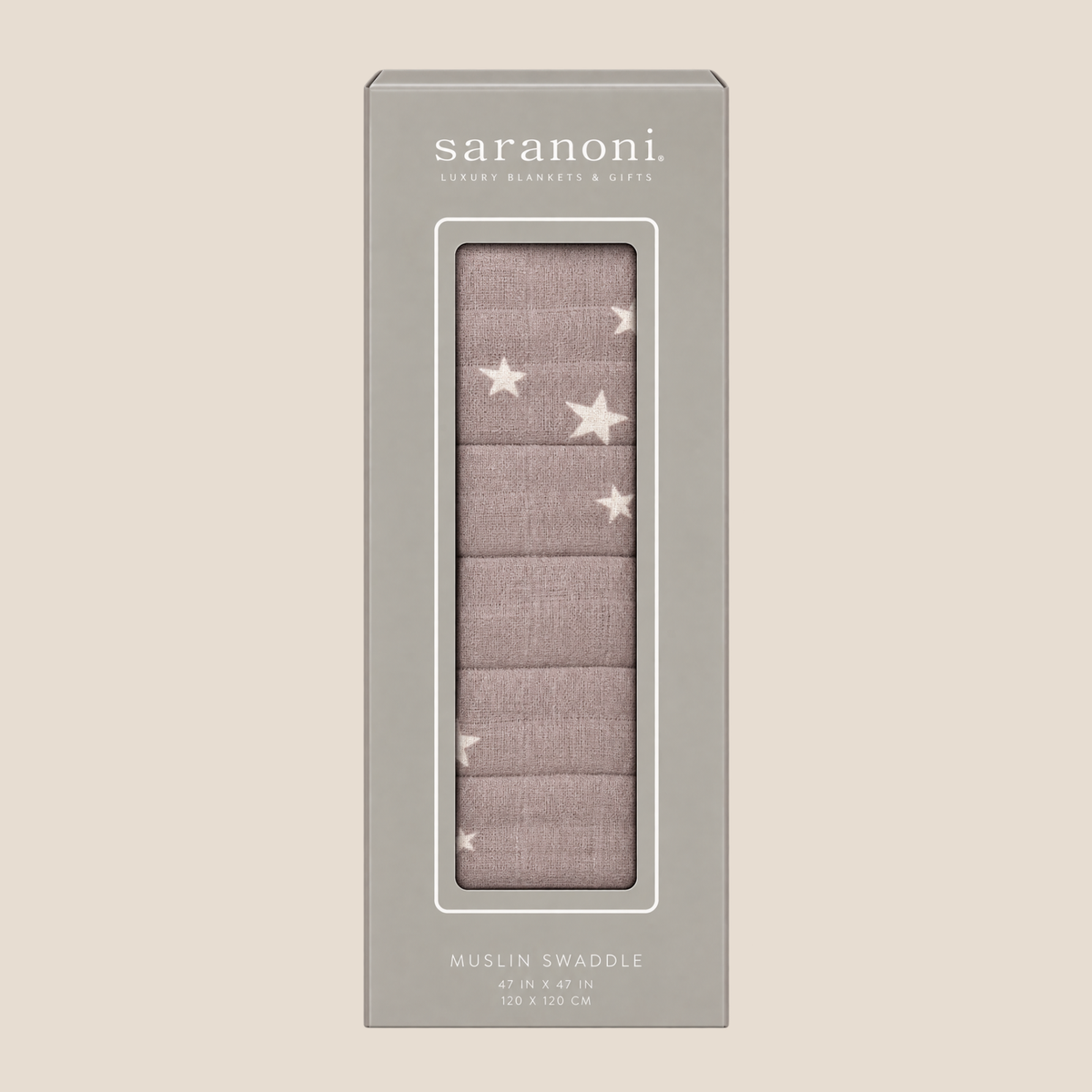 Saranoni Muslin Swaddle in a dusty mauve color with white embroidered stars, shown in its gray packaging box against a light beige background.