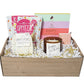 Gift basket with candles, cookies, and greeting cards on a gray background